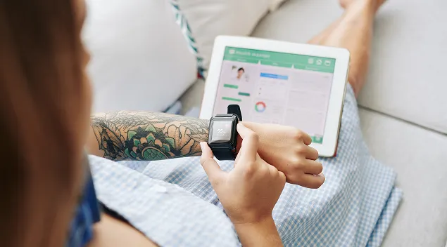 A woman analyzes health statistics on a watch