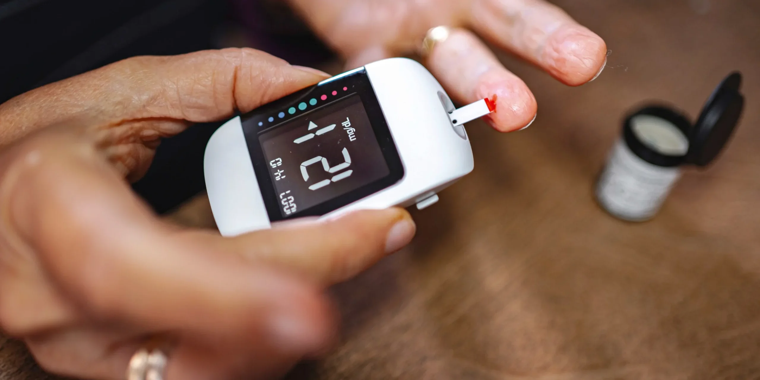 Checking blood sugar with a glucose monitor Person checking blood sugar with a glucometer during glucose monitoring