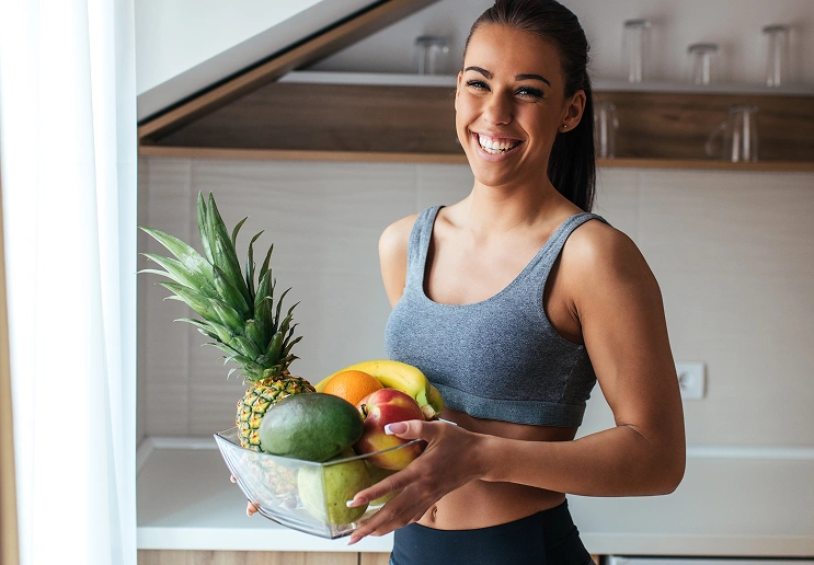 Woman holding a basket of fruit
